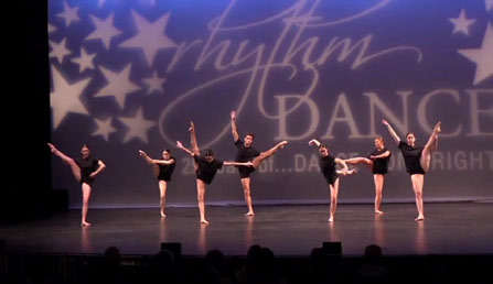 Input video frame: dancers on a lit stage