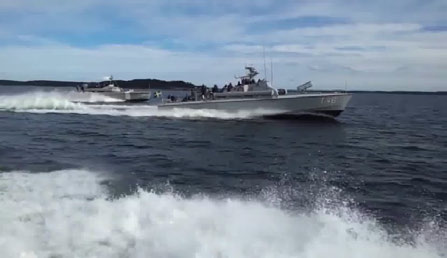 Input video frame: two military boats at speed